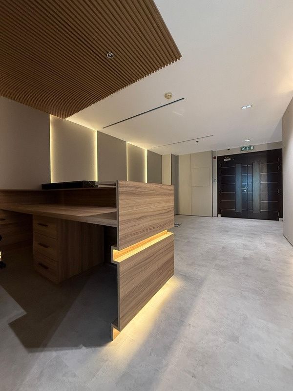 Timber reception desk with underlit plinth