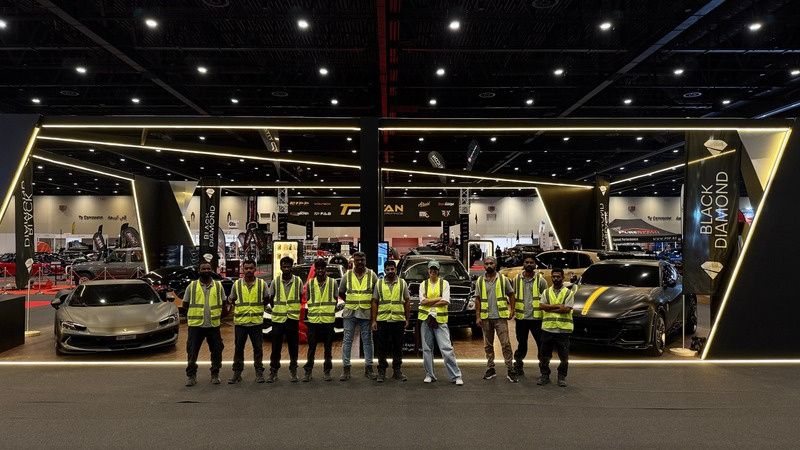 SKN team in front of a custom car exhibition stand