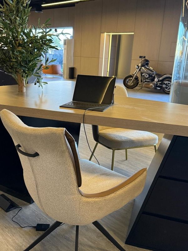 Sales desk with upholstered chairs